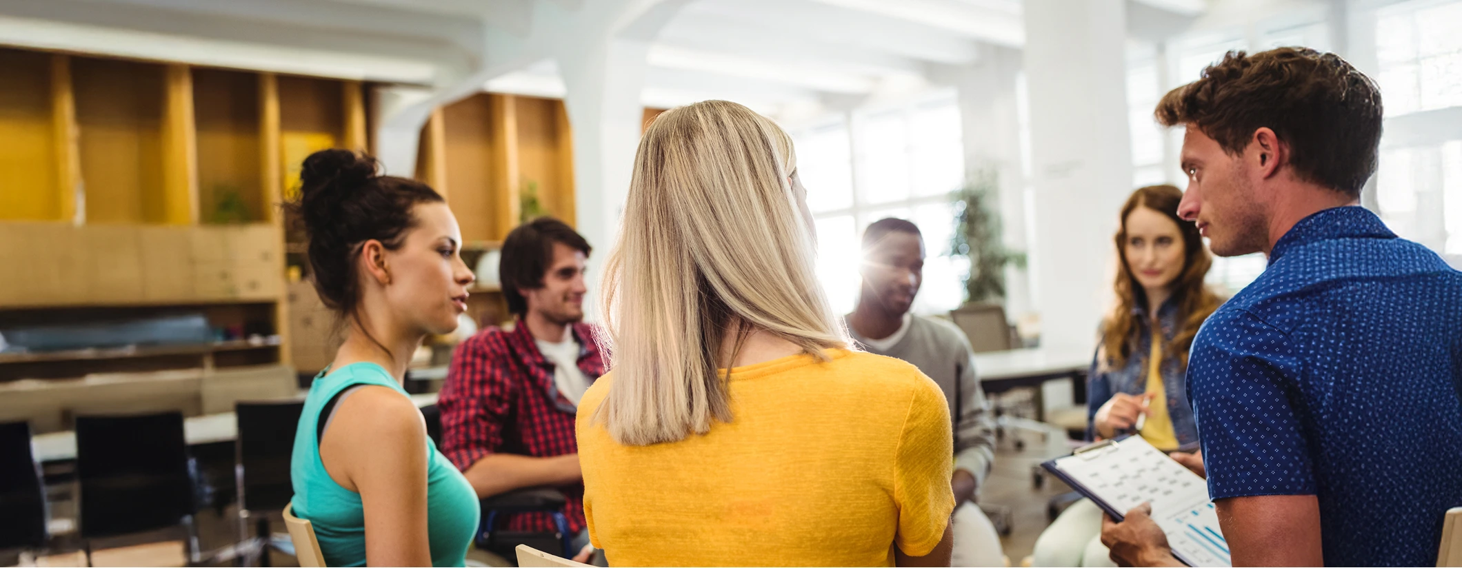 students sitting in circle having a discussion in classroom